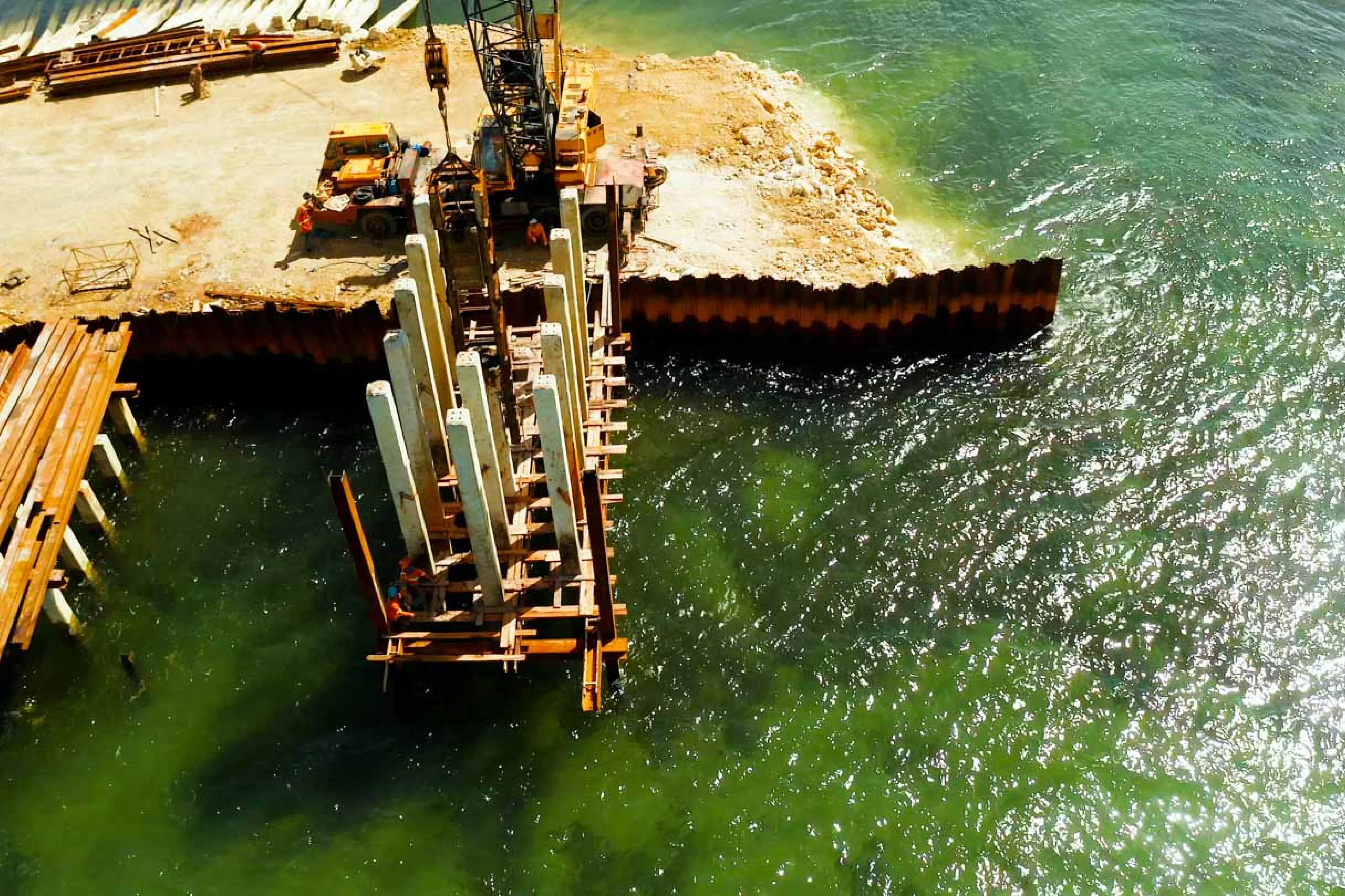 Pile driving pier extends over green water