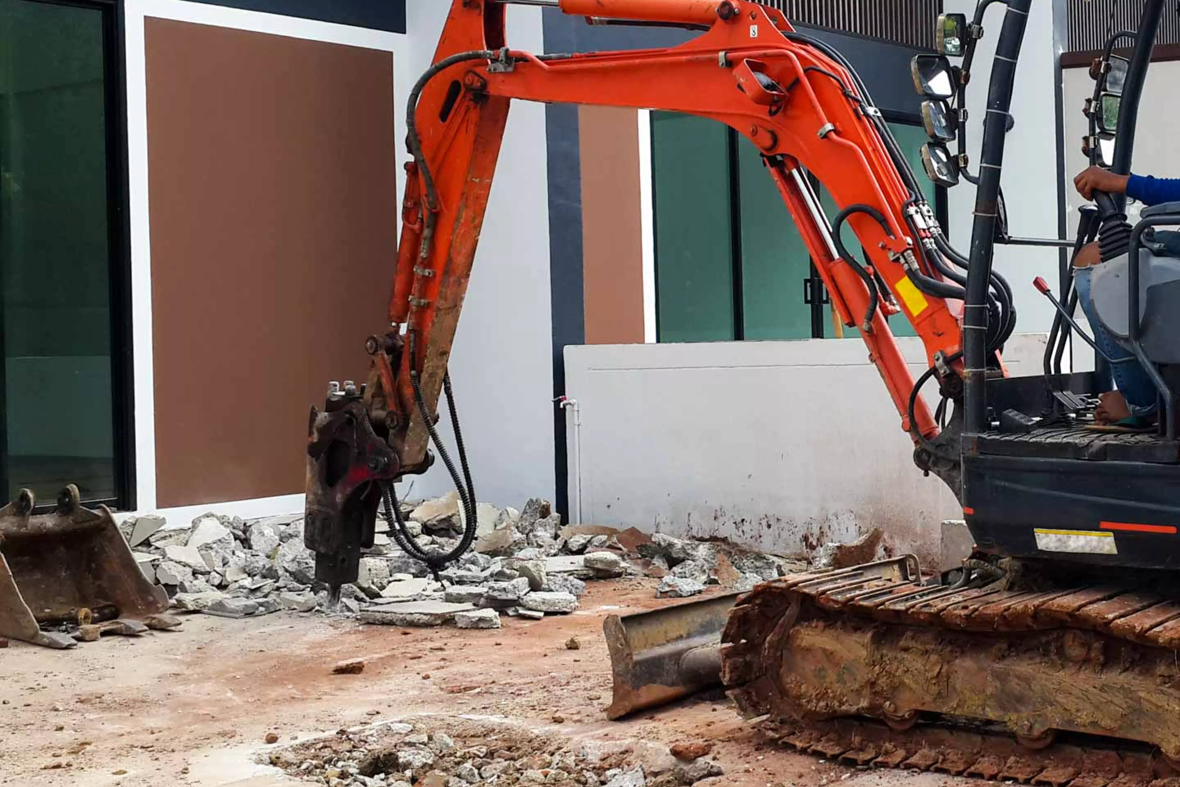 Backhoe moves rocks at construction site