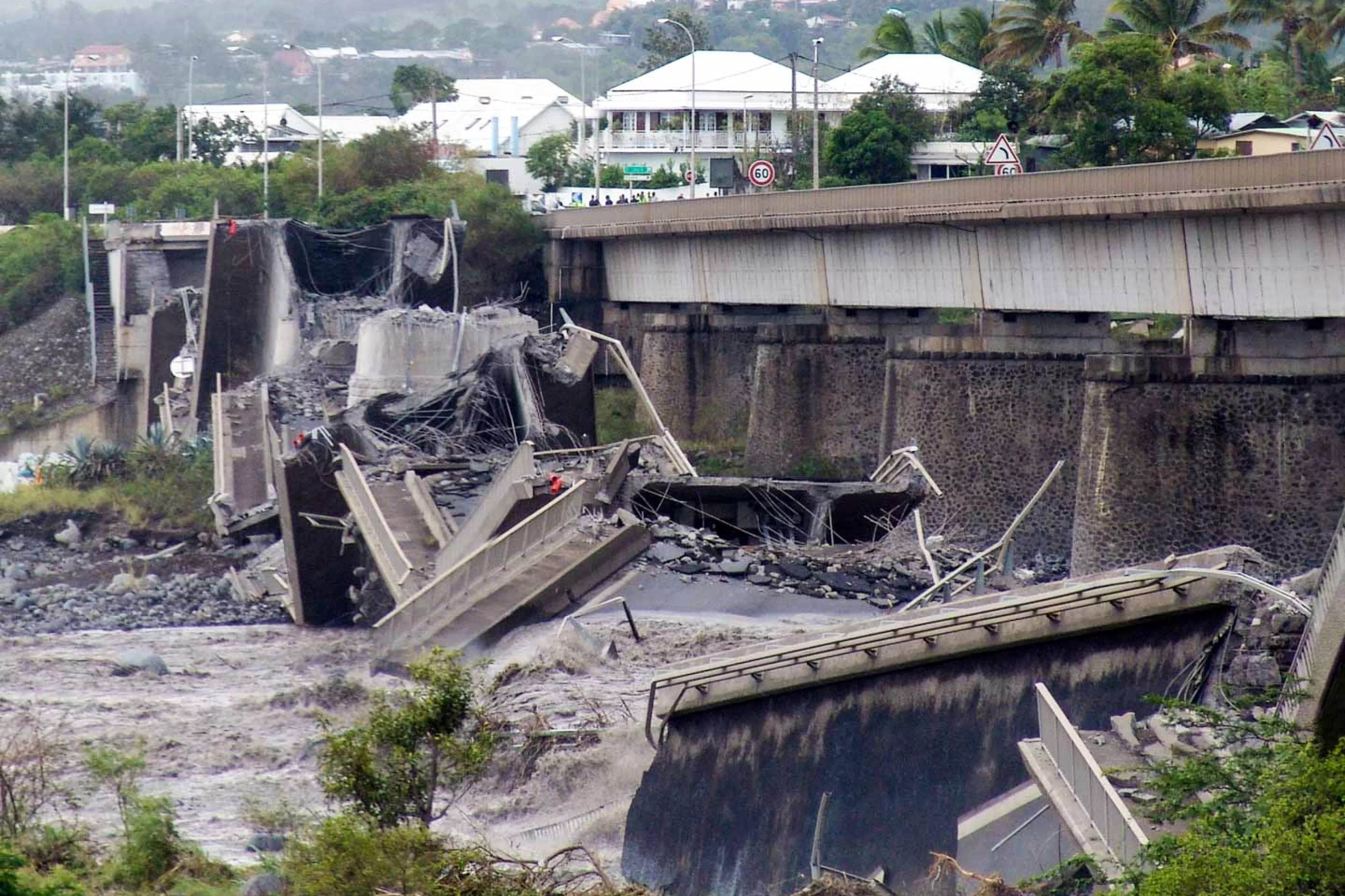 Demolished road bridge over river