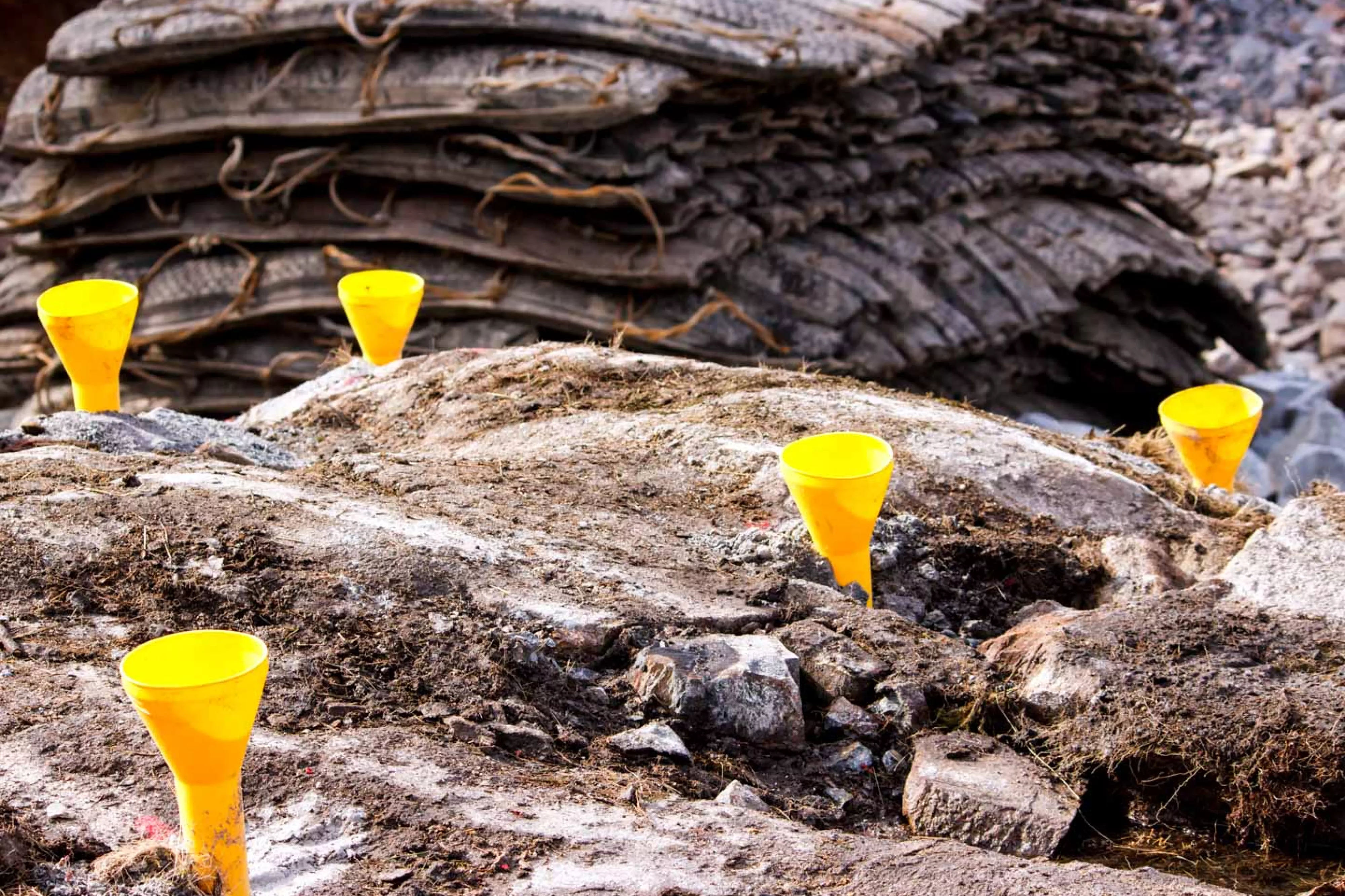 Yellow hole plugs in rocks at blasting site