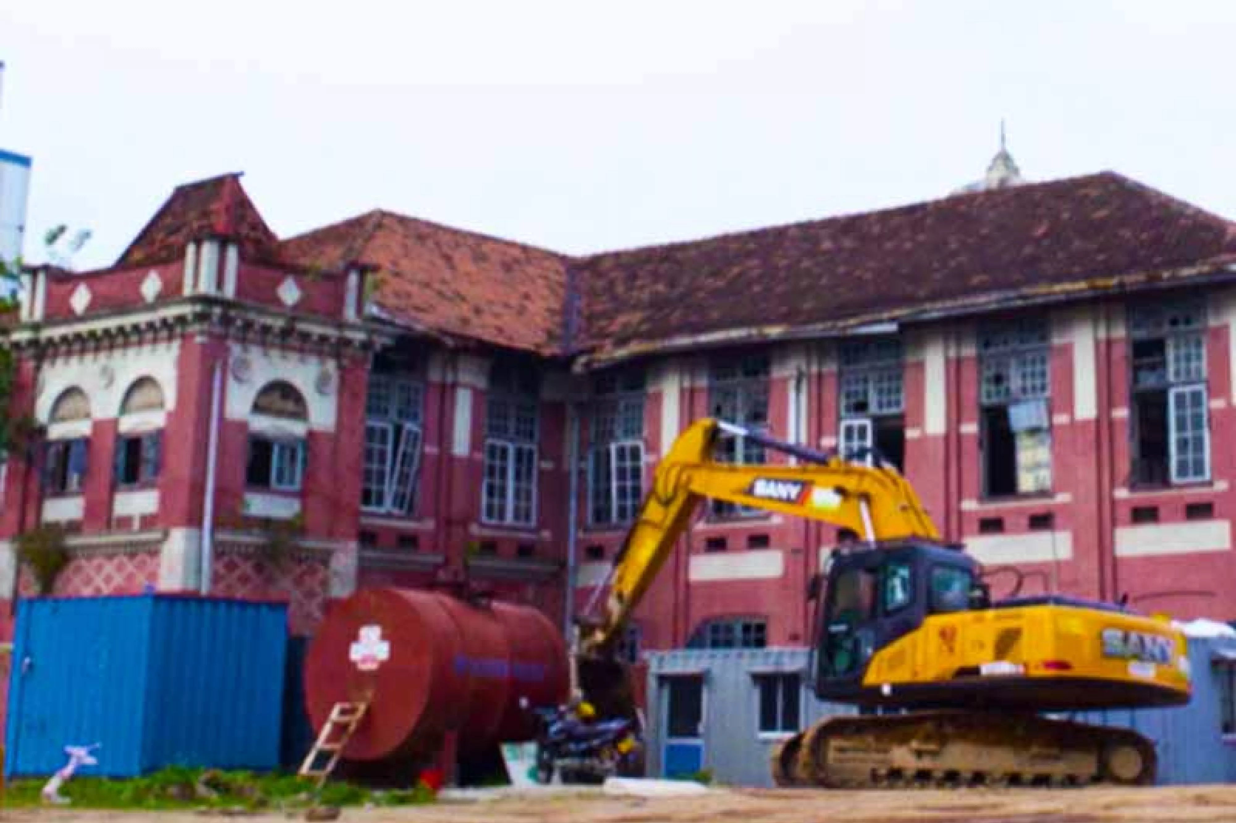 Transworks House with backhoe outside