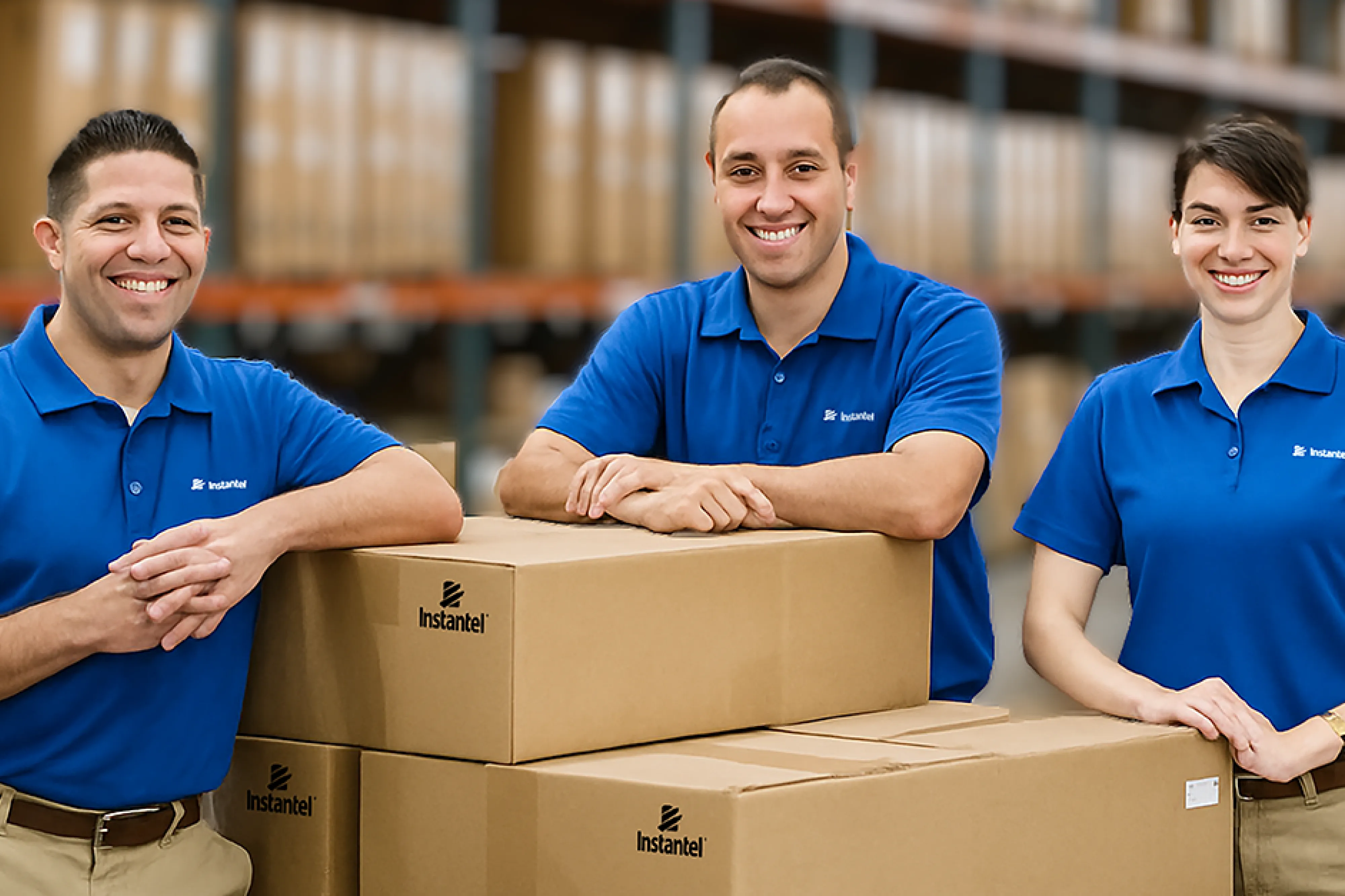 Three shipping and logistics employees in the Instantel warehouse