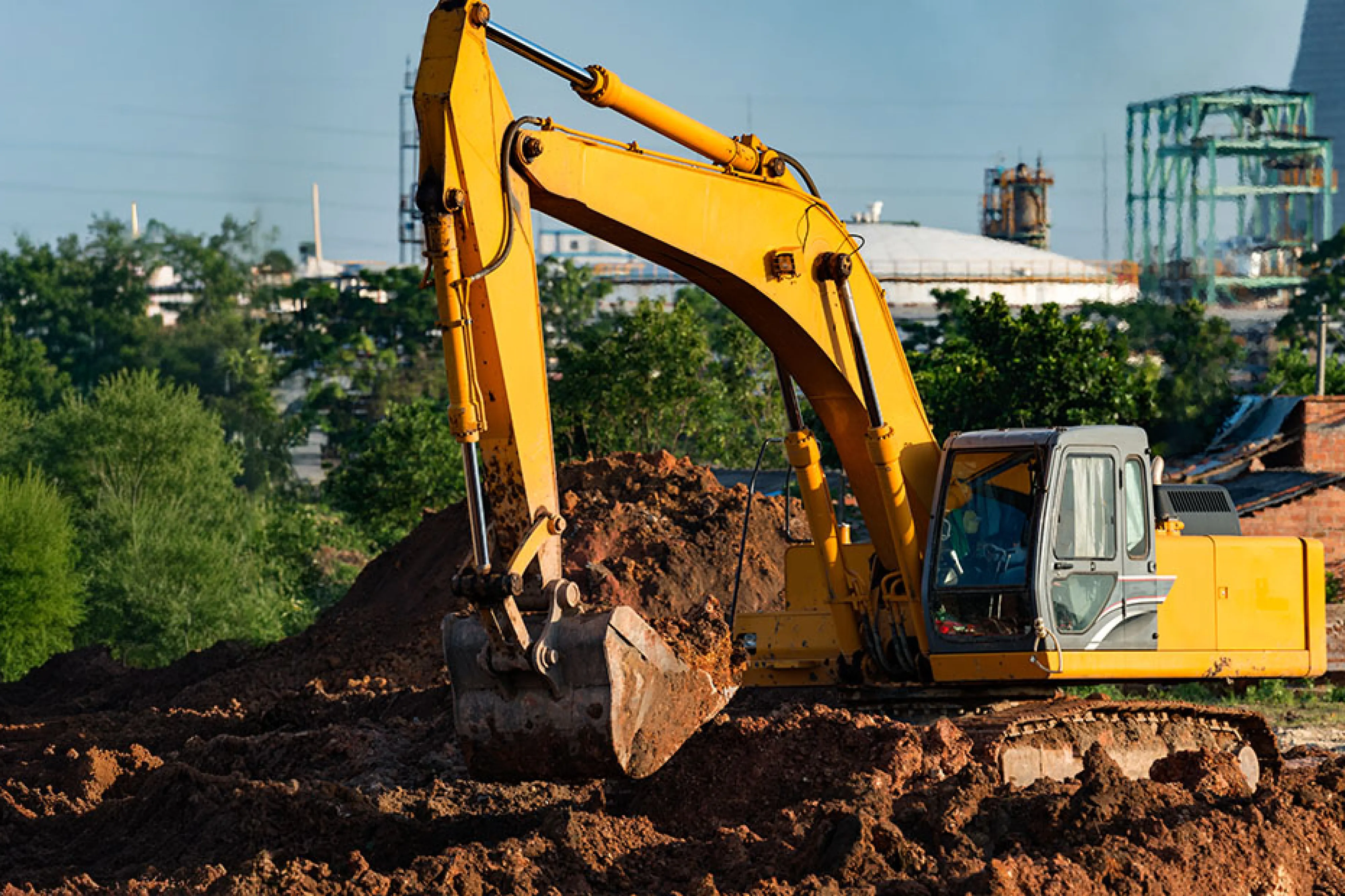 A construction excavator digging up soil