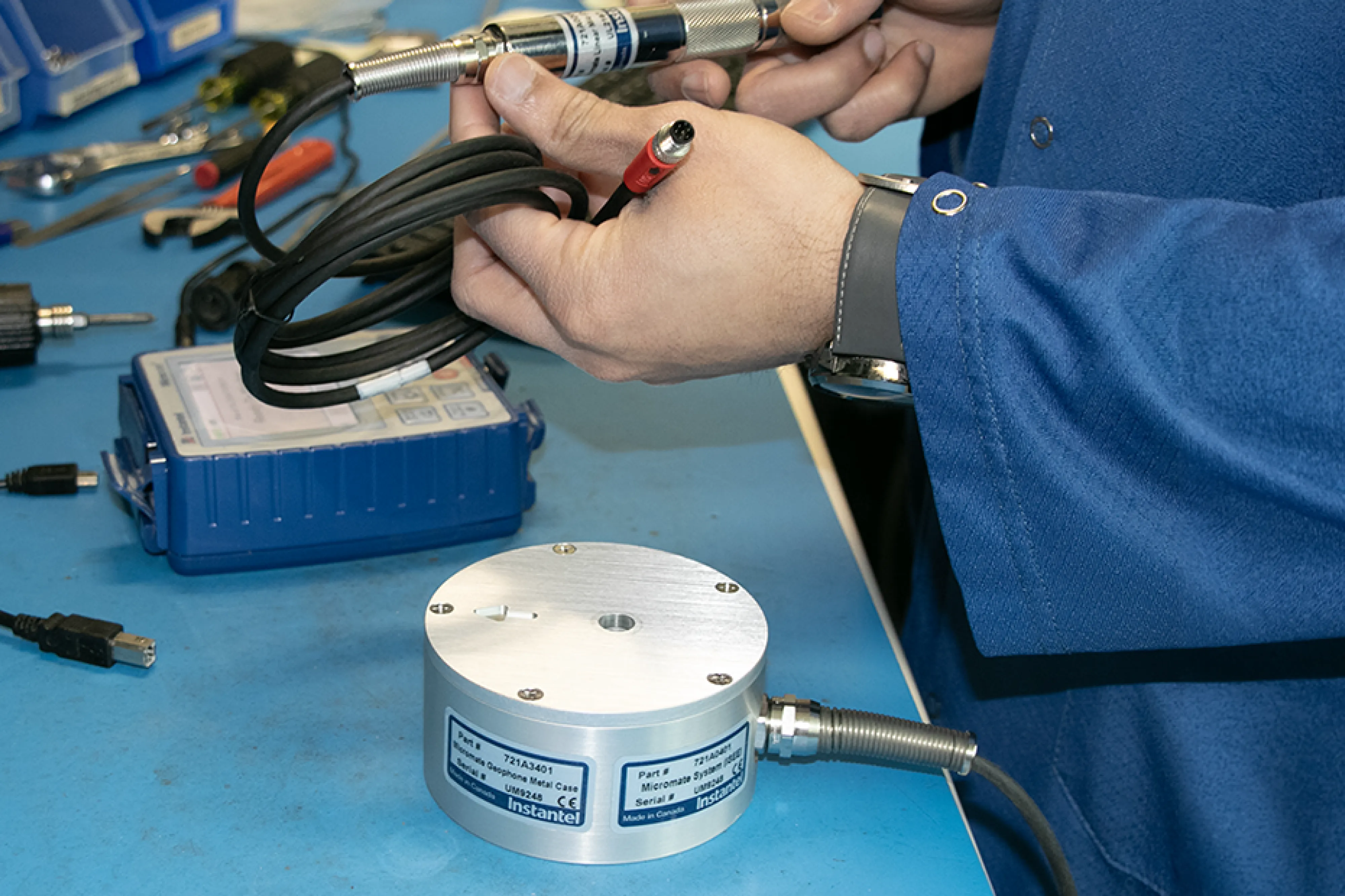 Instantel technician reviewing a Micromate and sensors