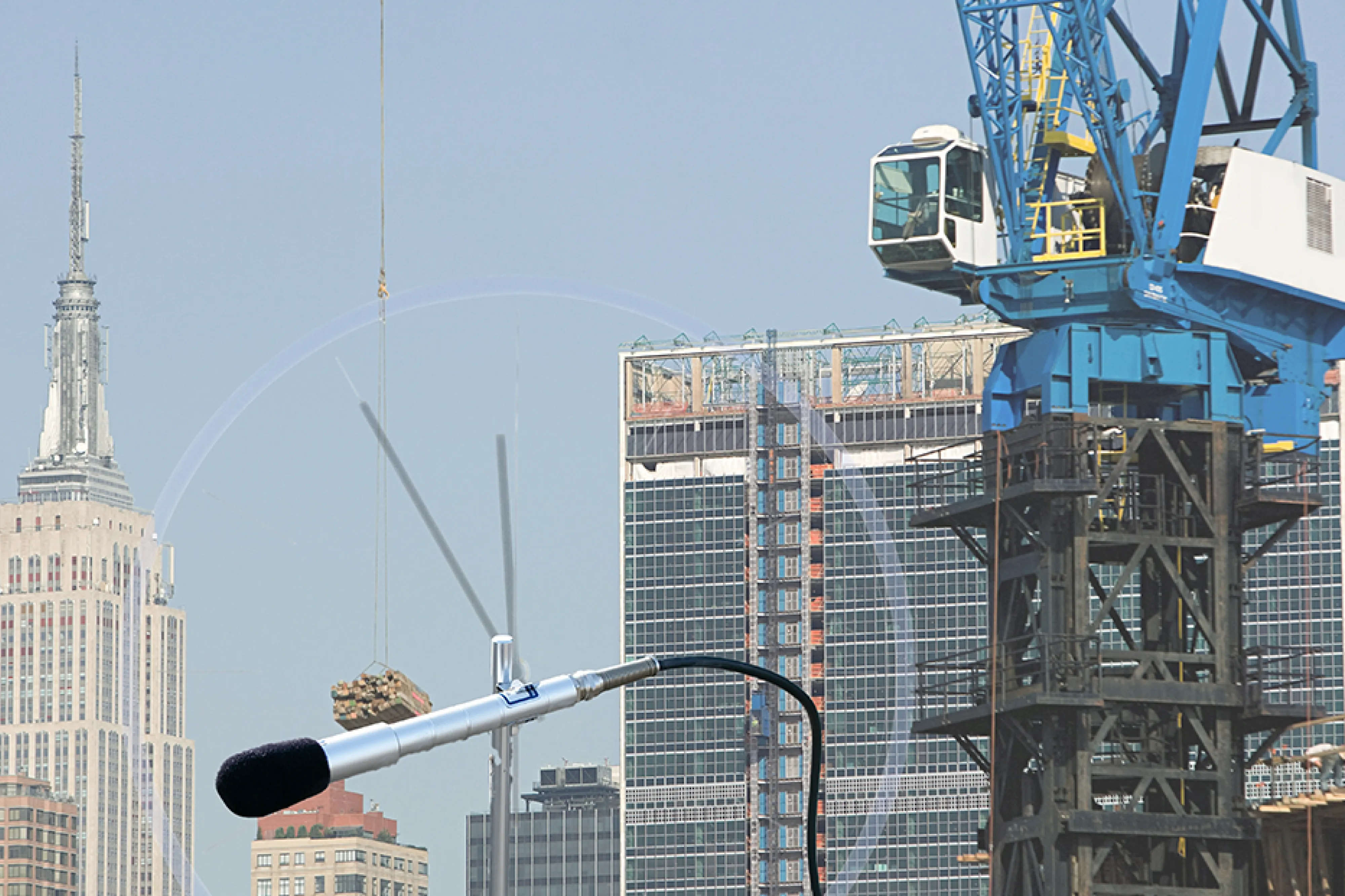 An image of the New York Skyline and a sound level microphone