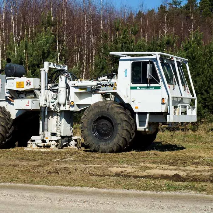 Seismic vibrator truck on side of dirt road