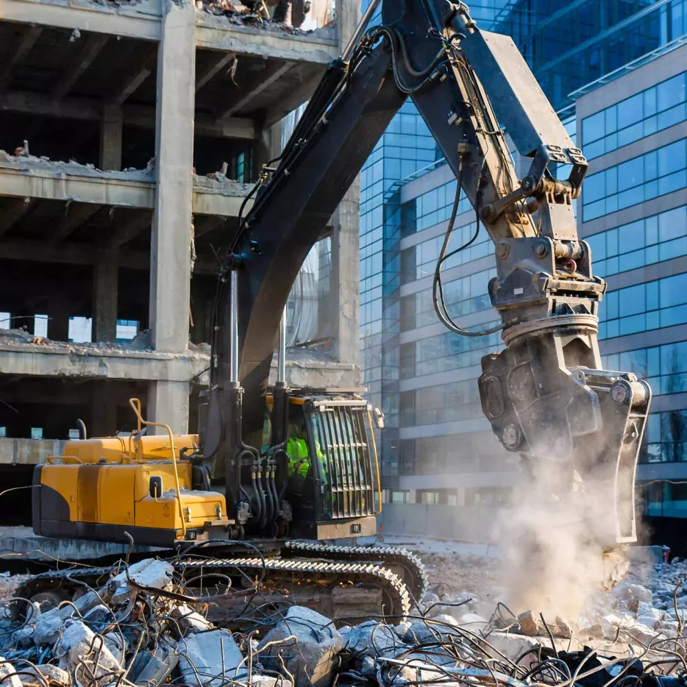 Backhoe at building demolition site