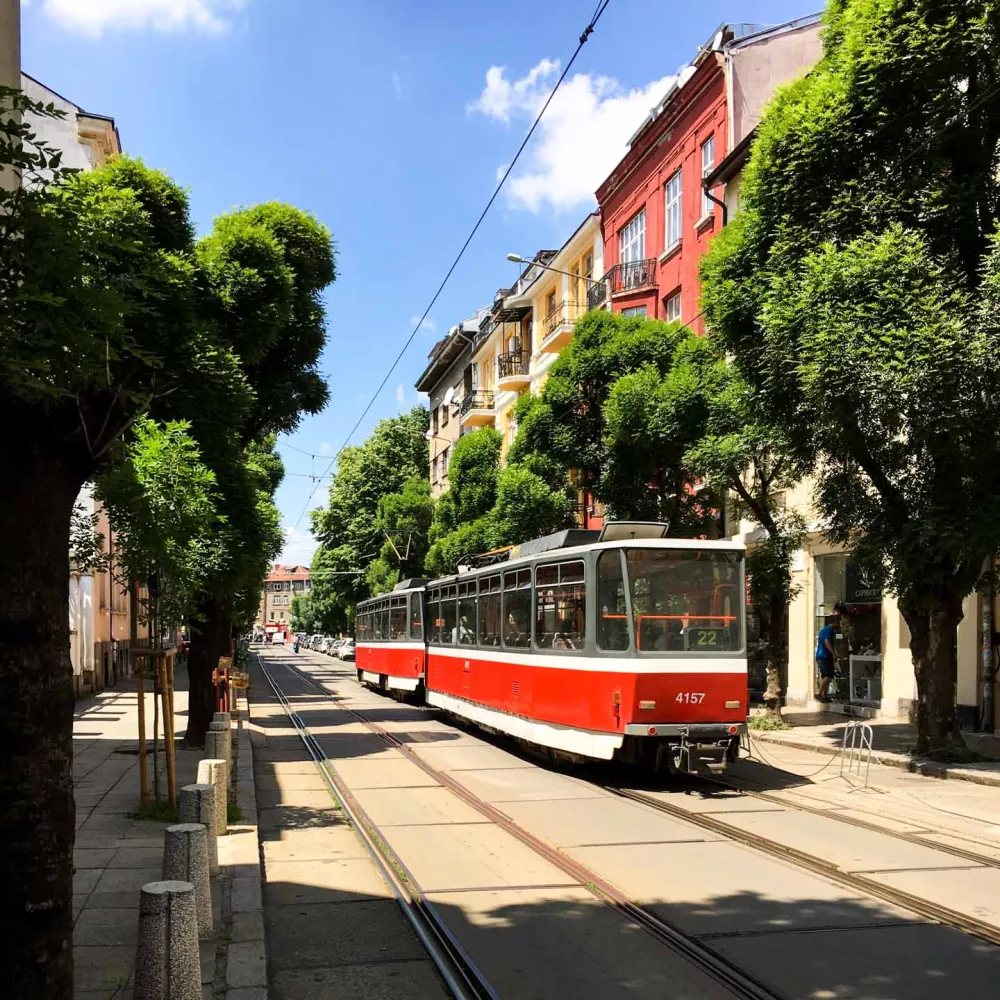 Red trolley on city road