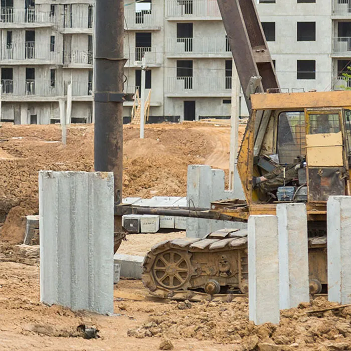 Pile driving stakes in the ground