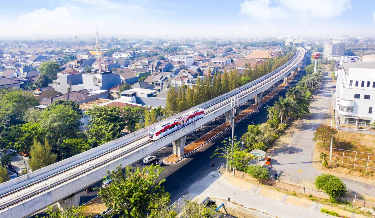 Elevated train passes in front of Jakarta cityscape